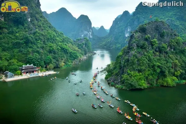 Tourists boating on Sao Khe River, weaving through caves in Trang An