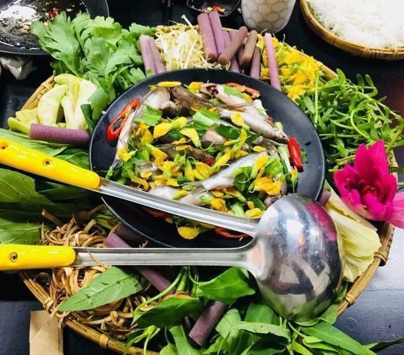 Hot pot with linh fish and sesbania sesban flowers - a Mekong Delta floating season specialty