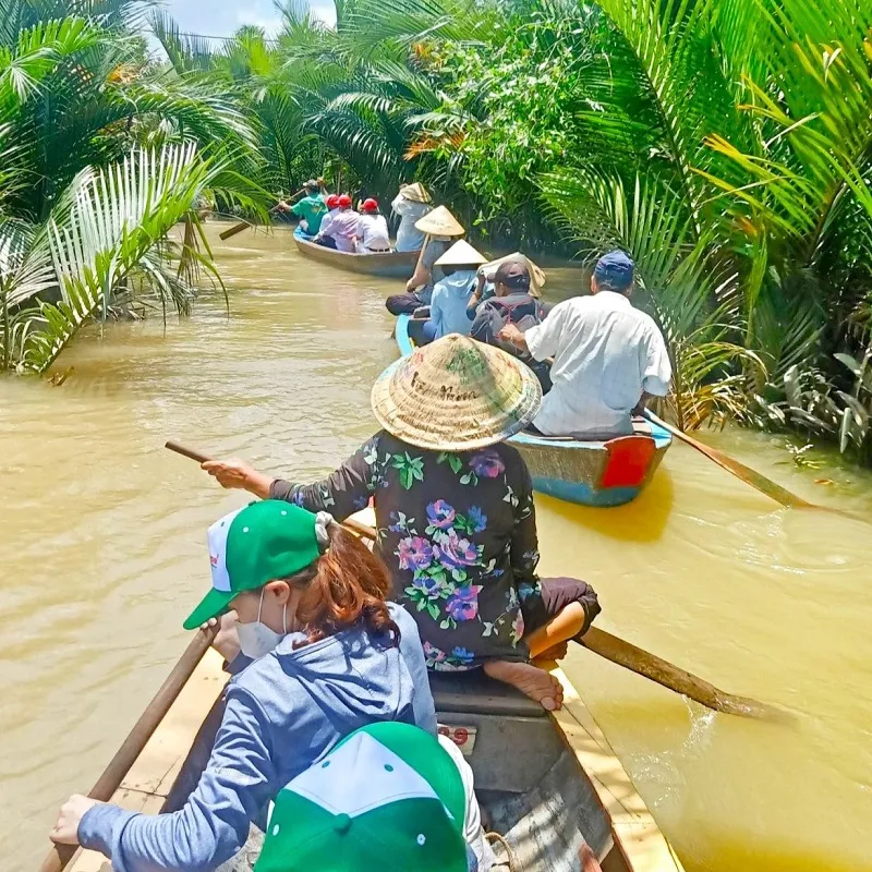 Happy tourists taking souvenir photos during the Mekong Delta floating season