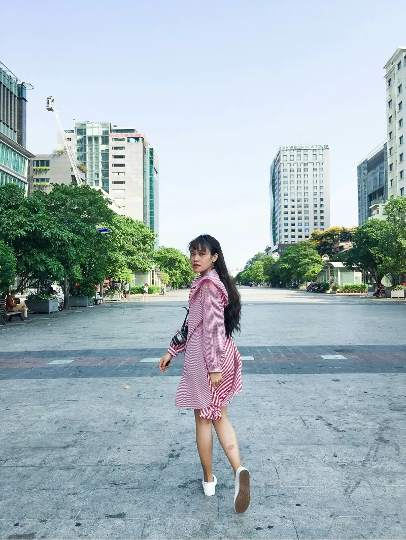 People taking photos at night on Nguyen Hue Walking Street, Saigon