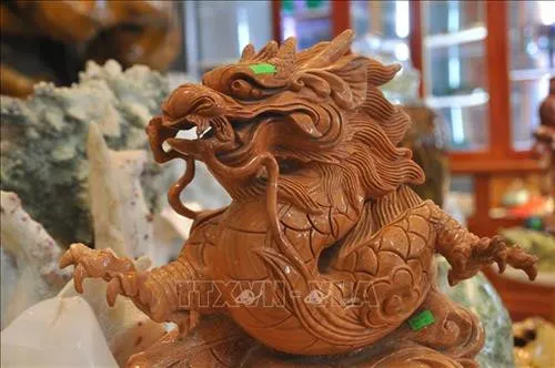 A dragon artwork being completed with sophistication from a rough stone.