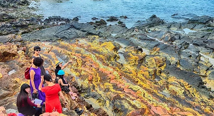 Dragon rocky beach Hai Hoa with brilliant orange-yellow rock slabs, stacked on top of each other, creating a unique and magical landscape