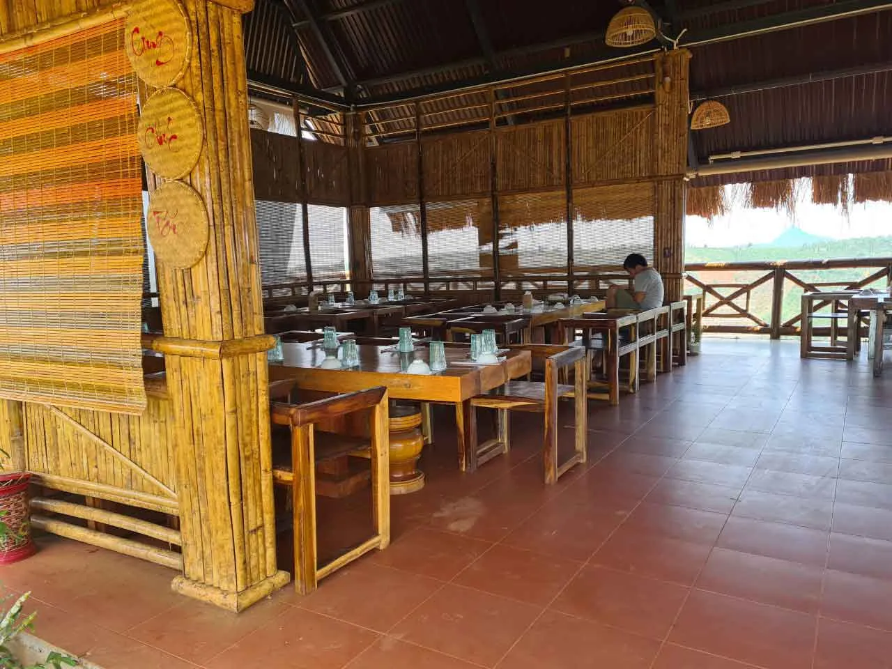Rustic wooden tables and chairs create a cozy and intimate atmosphere at K'Jang restaurant