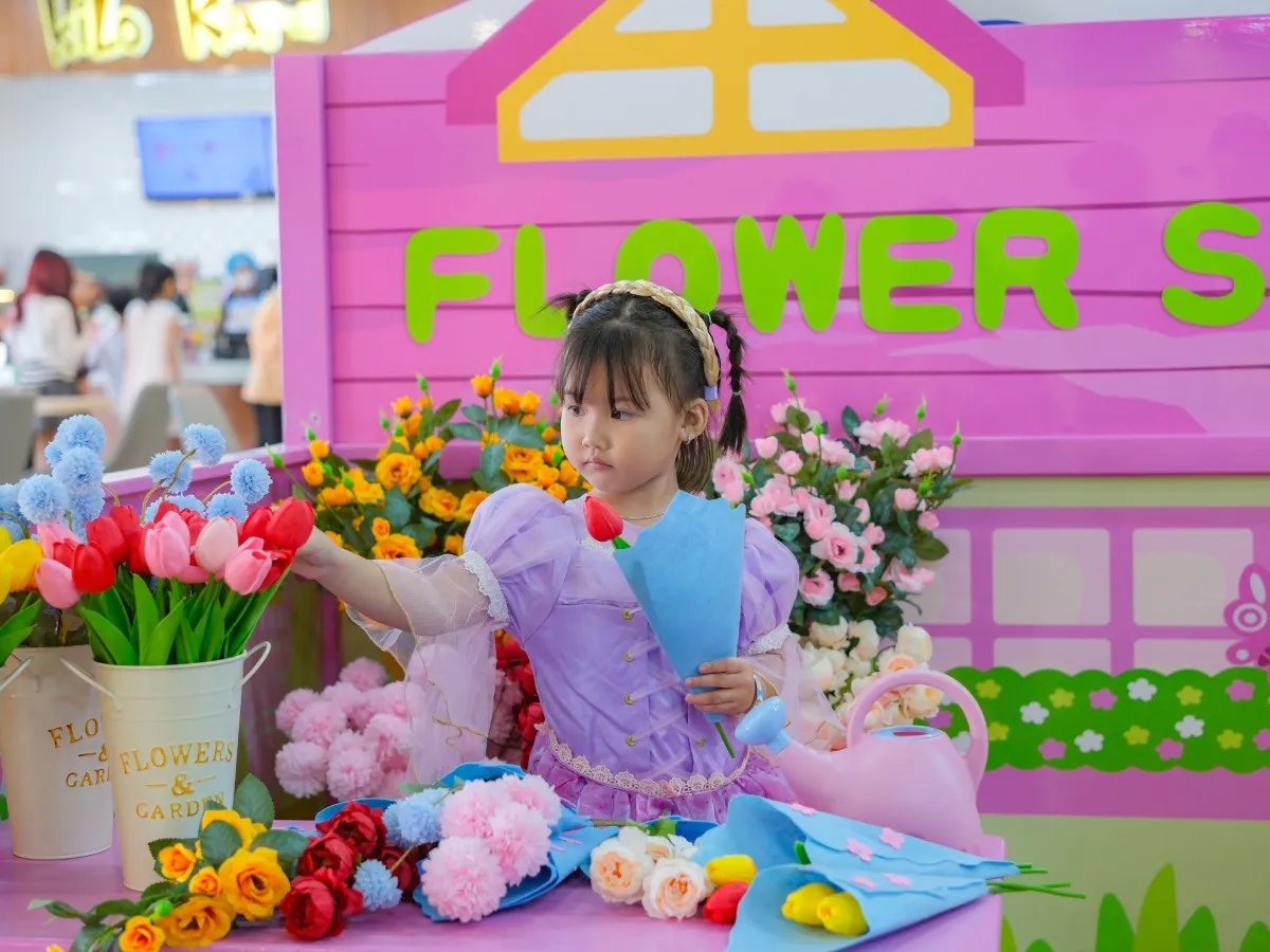 Girl playing with dolls and toys in tiNiWorld's girls' play area.