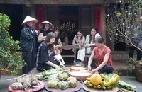 Các vị khách quốc tế trải nghiệm gói bánh chưng tại làng cổ Đường Lâm trong chương trình Tết làng Việt.