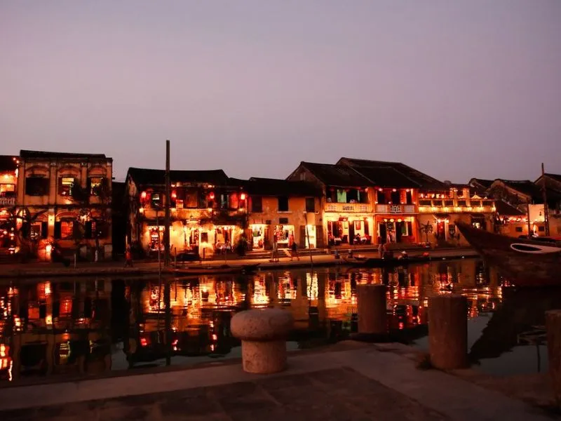Hoi An night market viewed from across the river, showcasing its vibrant atmosphere.