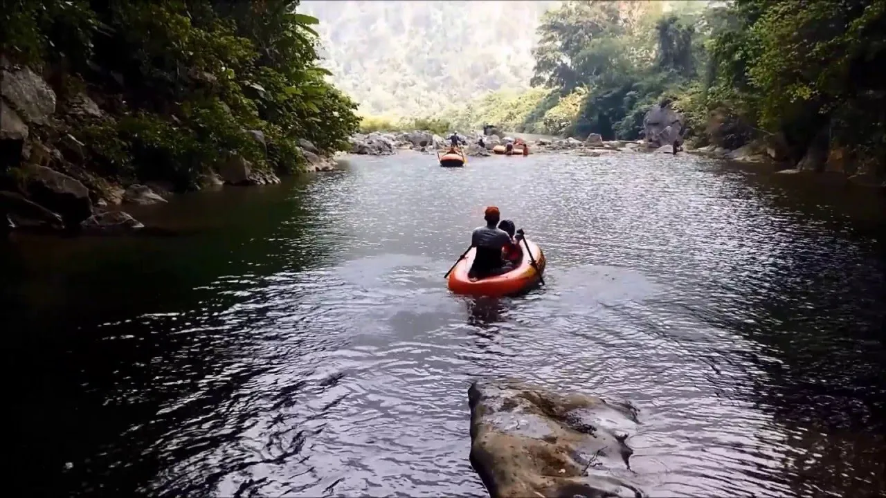 Swimming in the cool, clear water inside Ruc Mon Cave