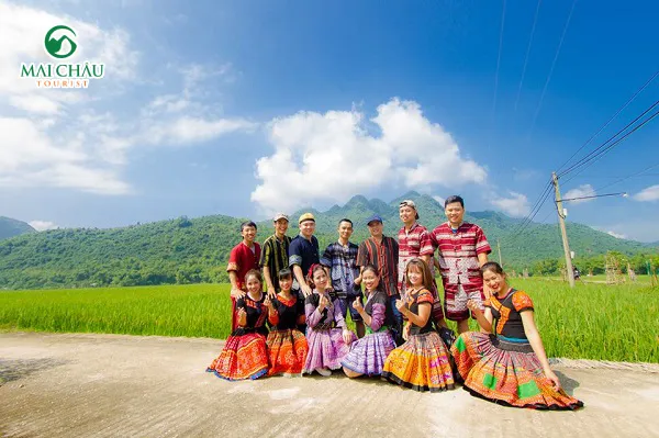 Person taking photos next to golden rice fields in Mai Chau
