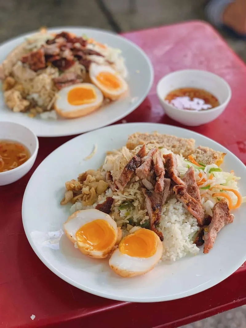 Cơm Tấm Bà Nẫm restaurant in Saigon, famous for its soft-boiled braised eggs, displaying a plate of broken rice with the signature egg dish.
