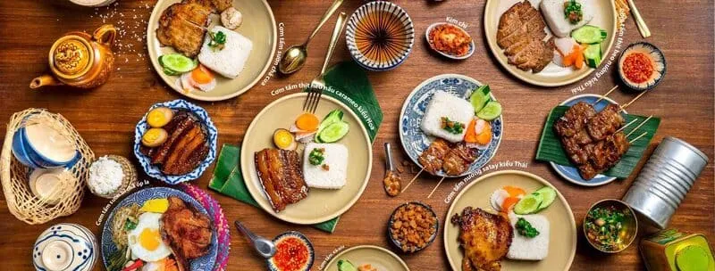 The interior of Cơm Tấm Mộc restaurant in Saigon, showing a rustic and cozy dining space with wooden furniture and traditional Vietnamese decorations.