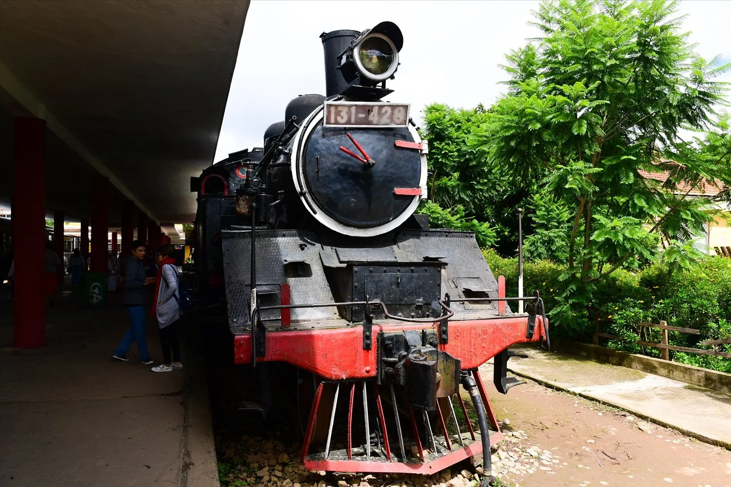 Vintage steam locomotive and cog railway track at Da Lat station platform