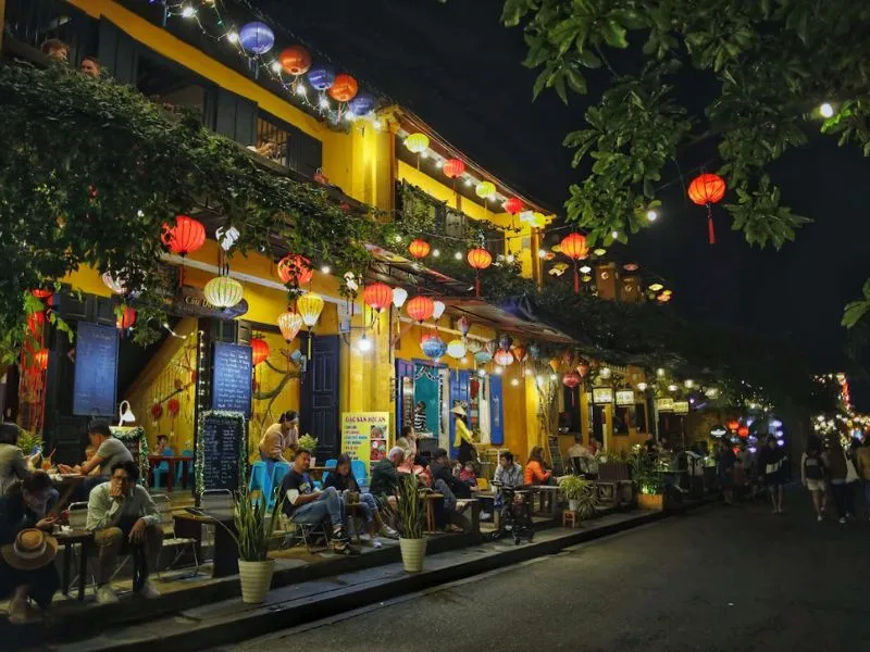 Lanterns, ancient houses, and golden lights define the charm of Hoi An night market.