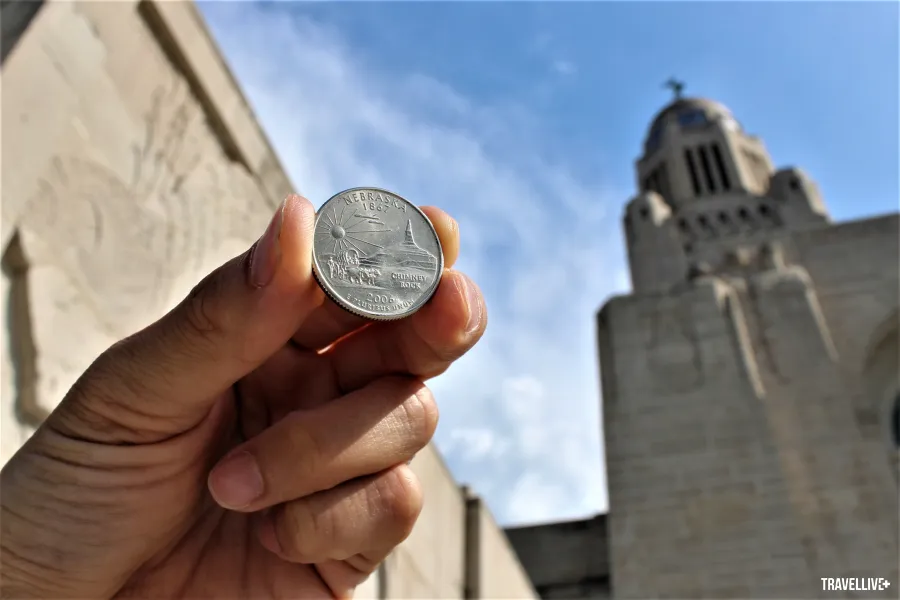 US quarter coin photographed at Nebraska State Capitol building