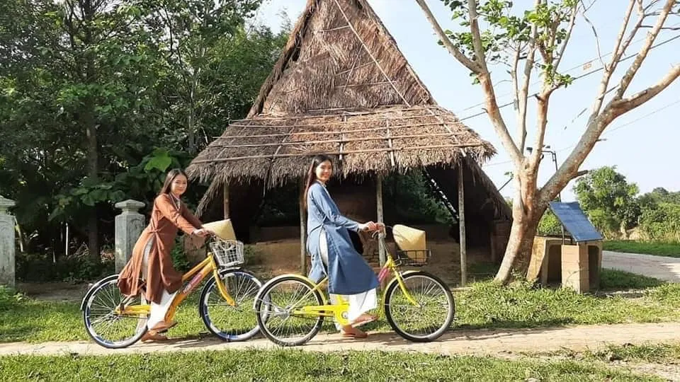Tourists cycling on the village road of Phuoc Tich, enjoying the peaceful atmosphere