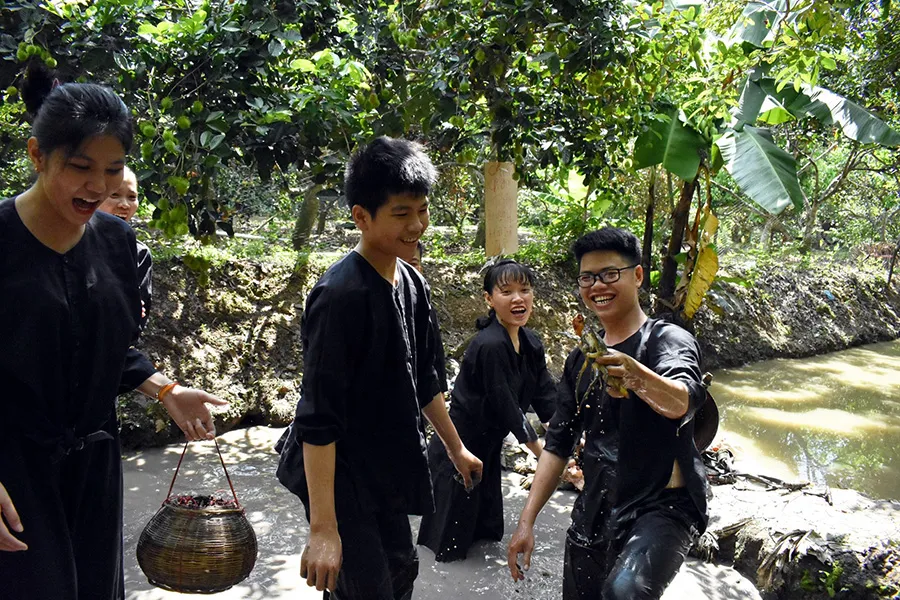 Tourists role-playing as farmers at Vinh Sang ecotourism area.