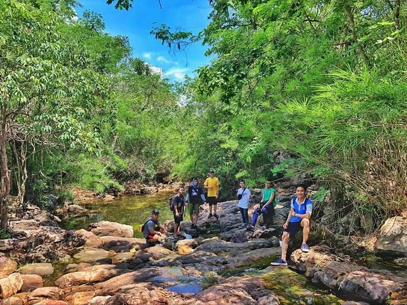 Visitors resting on the trekking trail of Cau Mountain