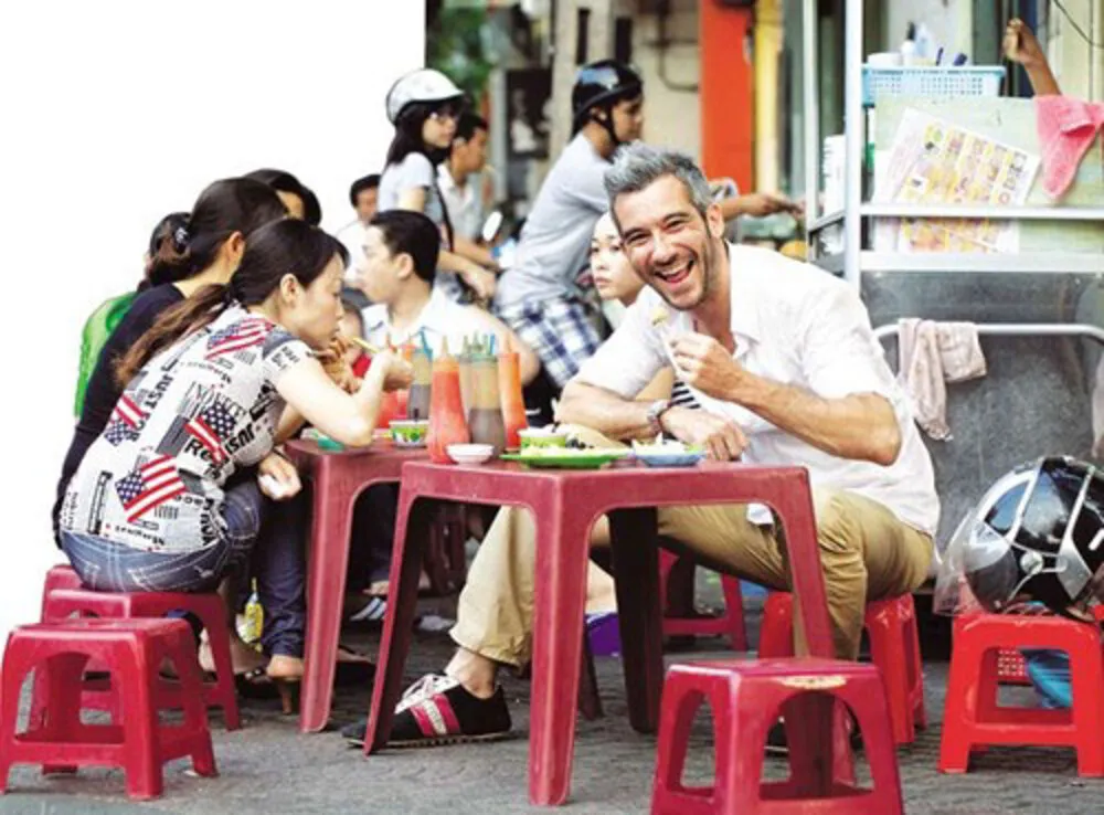 International tourists enjoy Vietnamese street food experience