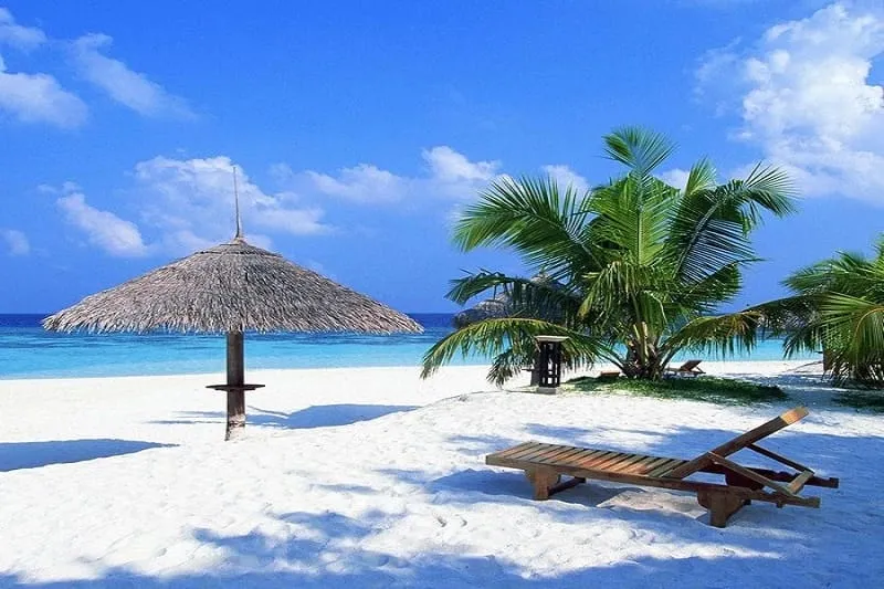 Tourists relaxing on Cua Dai beach with clear blue water