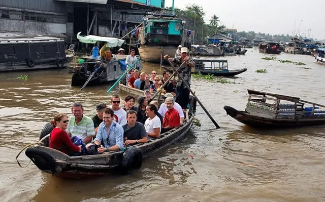 Tourists rent a boat to explore Cai Be Floating Market