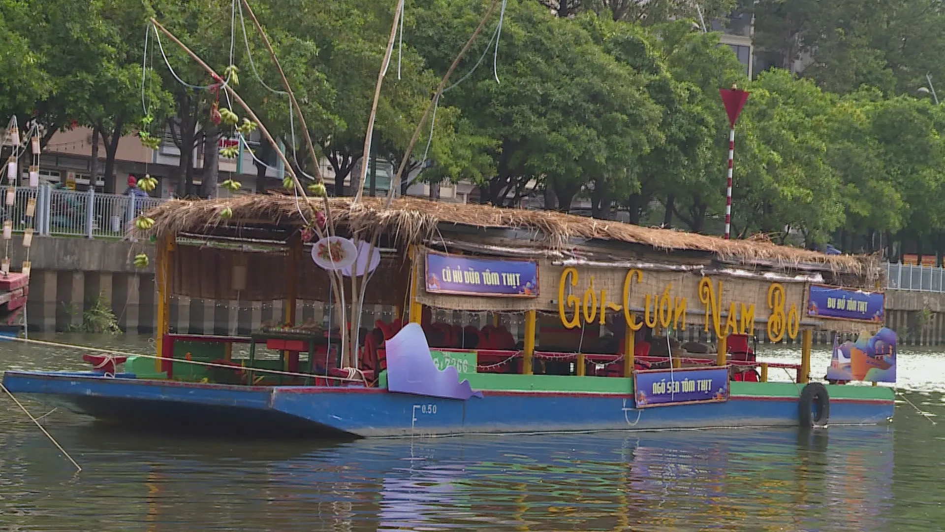 Tourists enjoying local cuisine from boats at a Mekong Delta floating market.