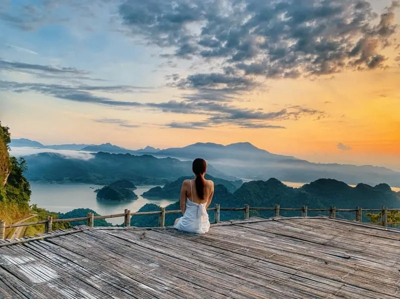 Peaceful Mai Chau with stilt houses and lush green rice paddies.
