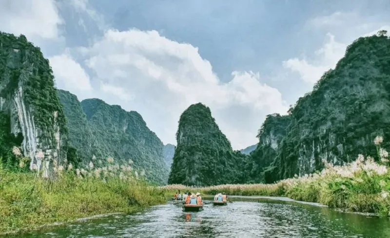 Boating on the clear Trang An River admiring the natural scenery