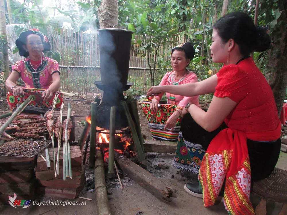 Sticky rice being carefully placed into bamboo tubes for Com Lam cooking in Thai Minh village, Nghe An, Vietnam.