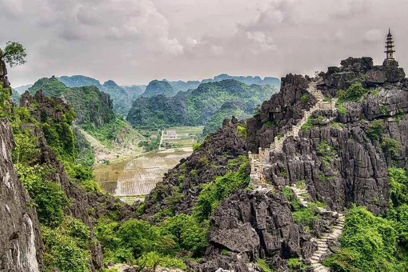 Stone steps winding up Mua Cave Mountain resembling the Great Wall of China