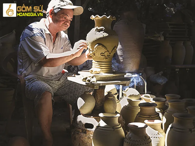 Portrait of a Bien Hoa pottery artisan diligently working, creating exquisite pottery products