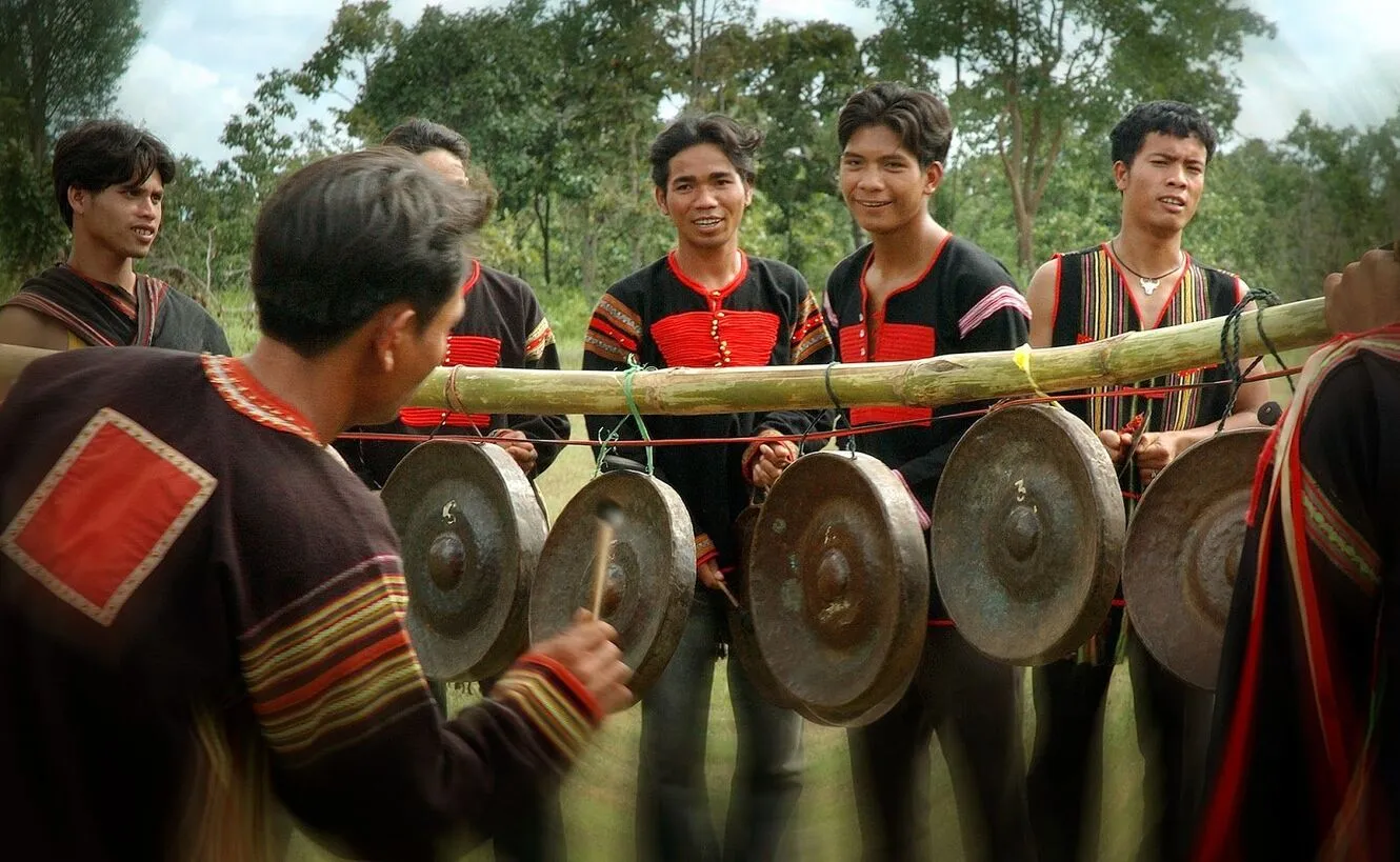 Image of a village boy playing gongs