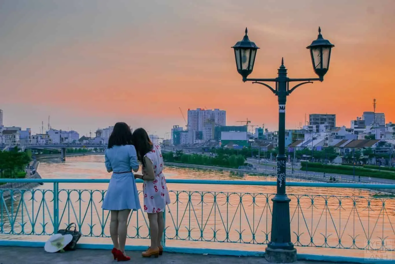 Sunset at Mong Bridge, Saigon, where twilight shines on the canal and high-rise buildings, creating a modern beauty.