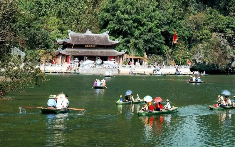 Large crowds of pilgrims and peaceful natural space at Perfume Pagoda Festival, Hanoi, a famous spiritual destination