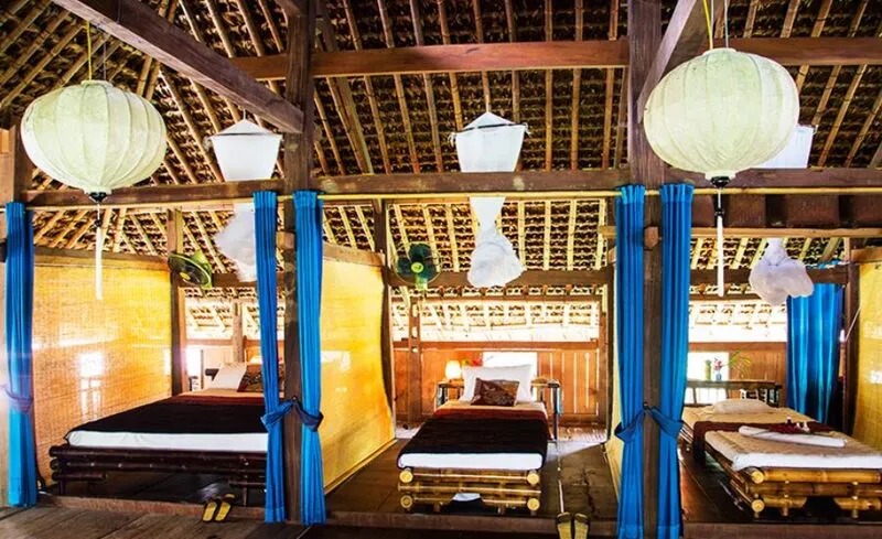 Ha Thanh Homestay with traditional Tay house architecture and fish pond