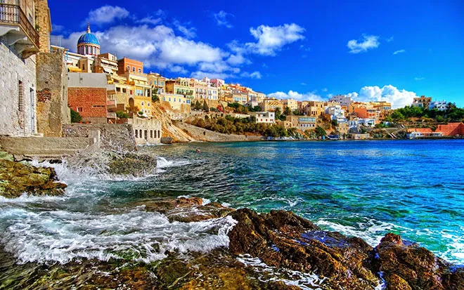 A scenic coastal village in Ikaria with traditional houses and the Aegean Sea