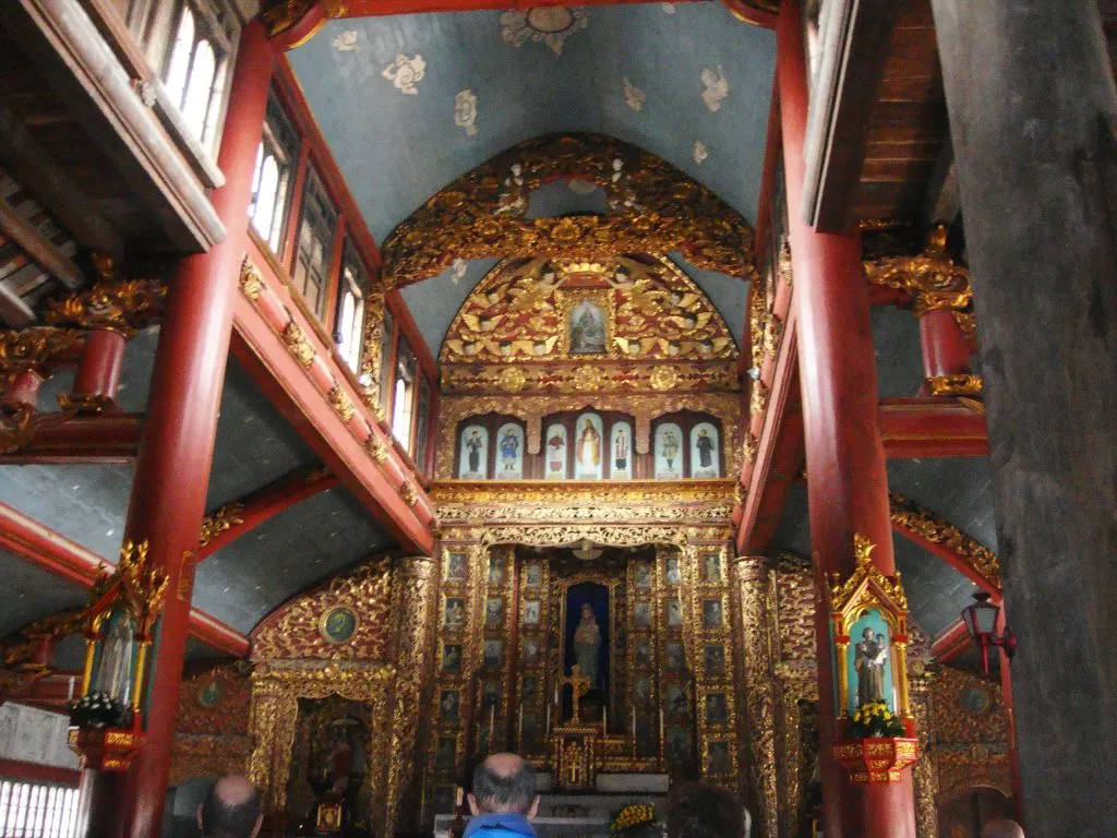 Shimmering space inside the sanctuary of Phat Diem Stone Cathedral