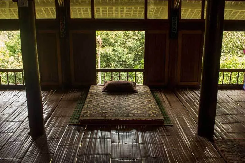 Simple sleeping space, blending into nature at Tho Homestay
