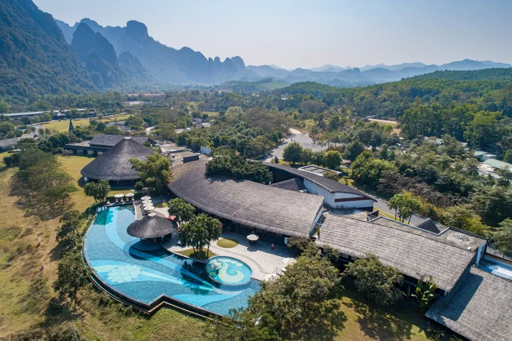 Outdoor swimming pool at Serena Resort Kim Boi with clear water and green space