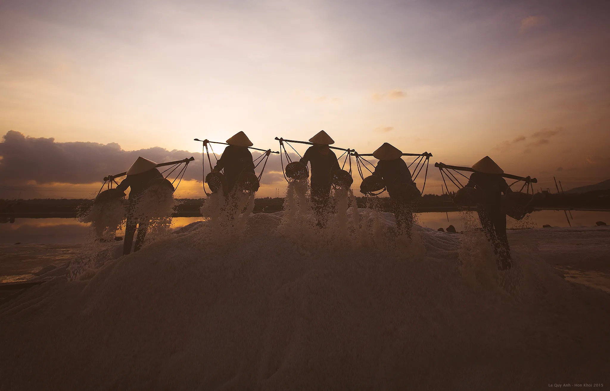 Salt farmers working in the Hon Khoi salt fields in Ninh Hoa, Vietnam