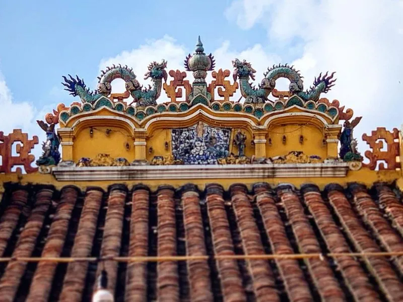 Giac Lam Pagoda's roof with unique twin dragons flanking a pearl image