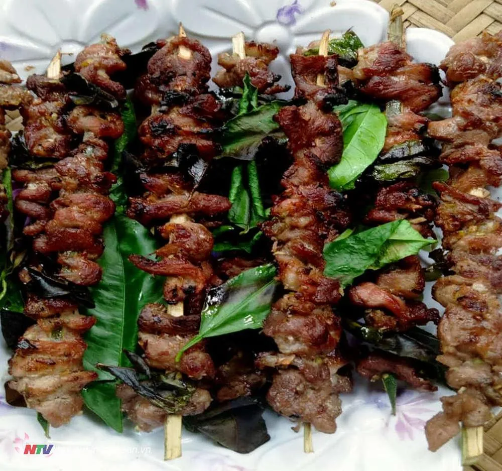 Delicious grilled meat, a key part of a traditional meal for guests in Thai Minh village, Nghe An, Vietnam.