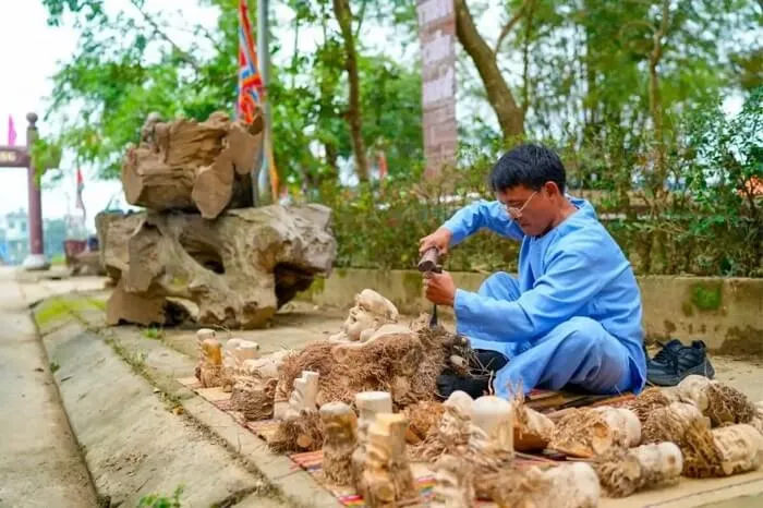 Artisan in Kim Bong Carpentry Village crafting a wooden product