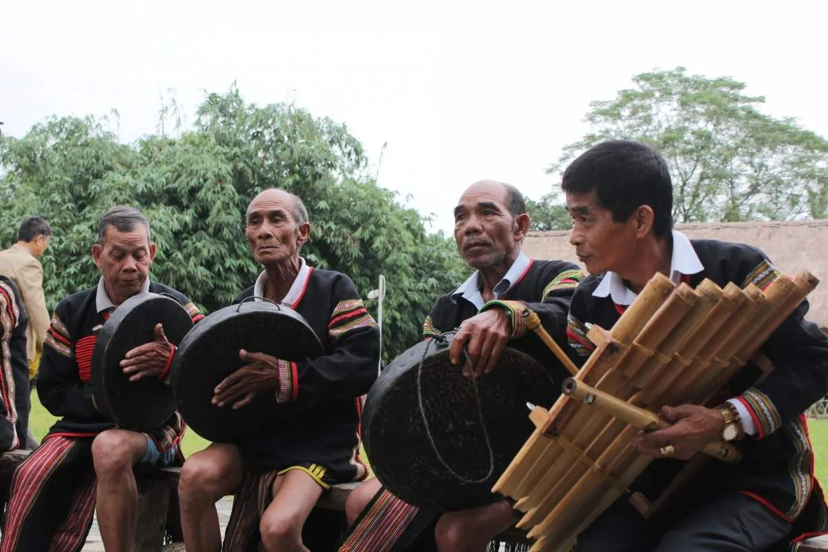 Elderly artisan demonstrating skillful wrist-hitting technique on gongs, preparing for an upcoming cultural festival.