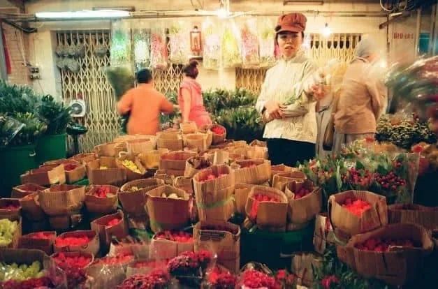 A flower vendor working late at night in Ho Thi Ky Flower Market.