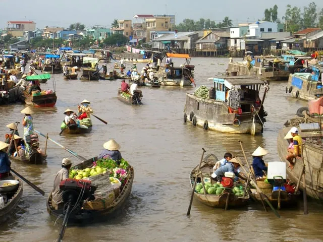 Locals mud bathing on a river islet near Cai Be Floating Market