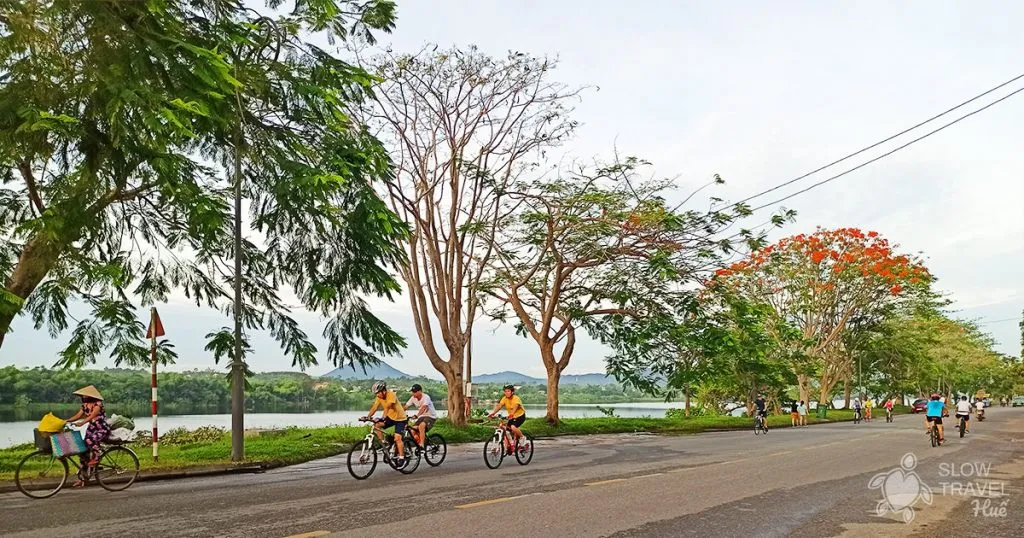 Hue people cycling along the Perfume River