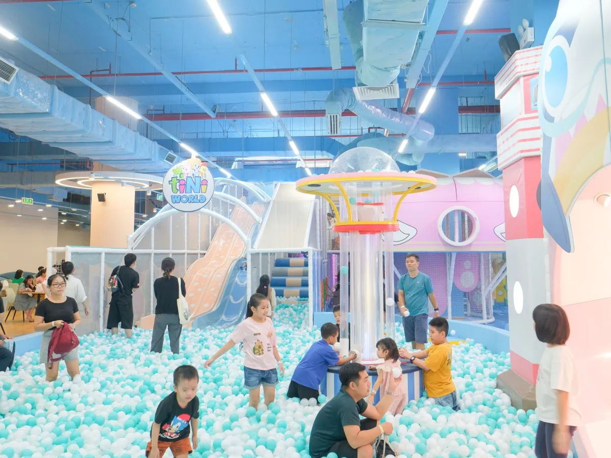 Children playing in a colorful ball pit at tiNiWorld.