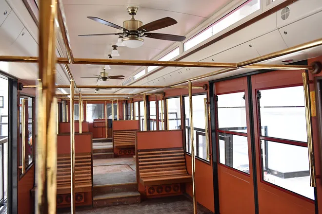 Interior view of a Muong Hoa mountain railway carriage with seating and large windows