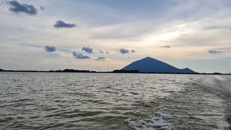 Ba Den Mountain hidden in the clouds seen from Nhim Island