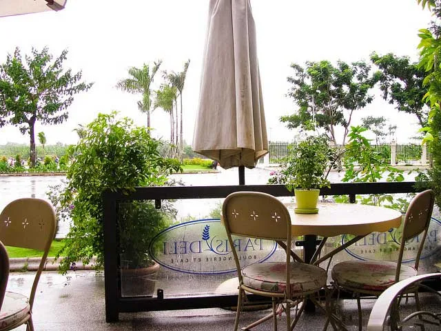 Cozy and romantic indoor seating area of Paris Deli Cafe, showcasing its Parisian-inspired decor and warm lighting.