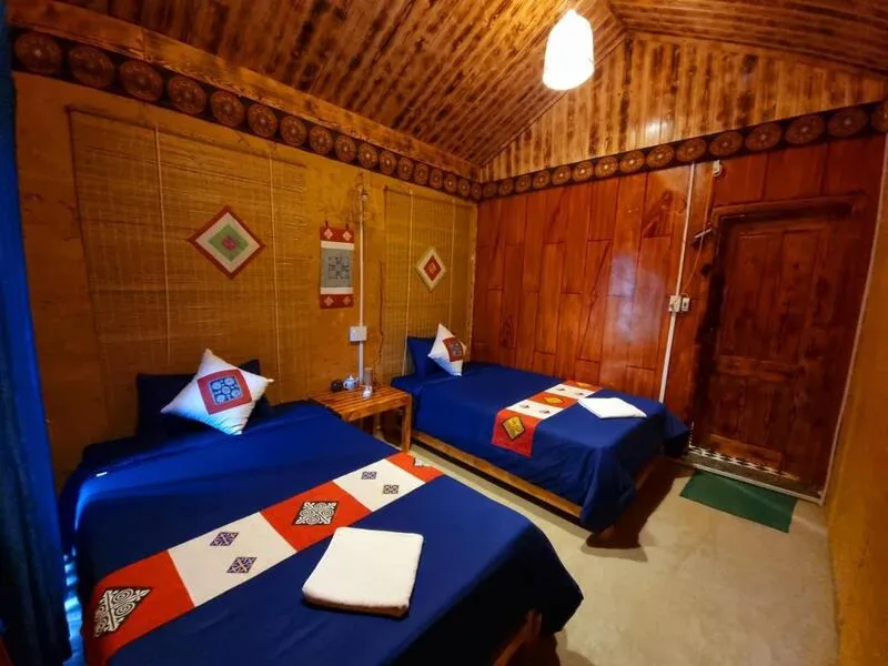 Bedroom at Quan Ba Chook Bungalow Homestay with simple, cozy design and natural light
